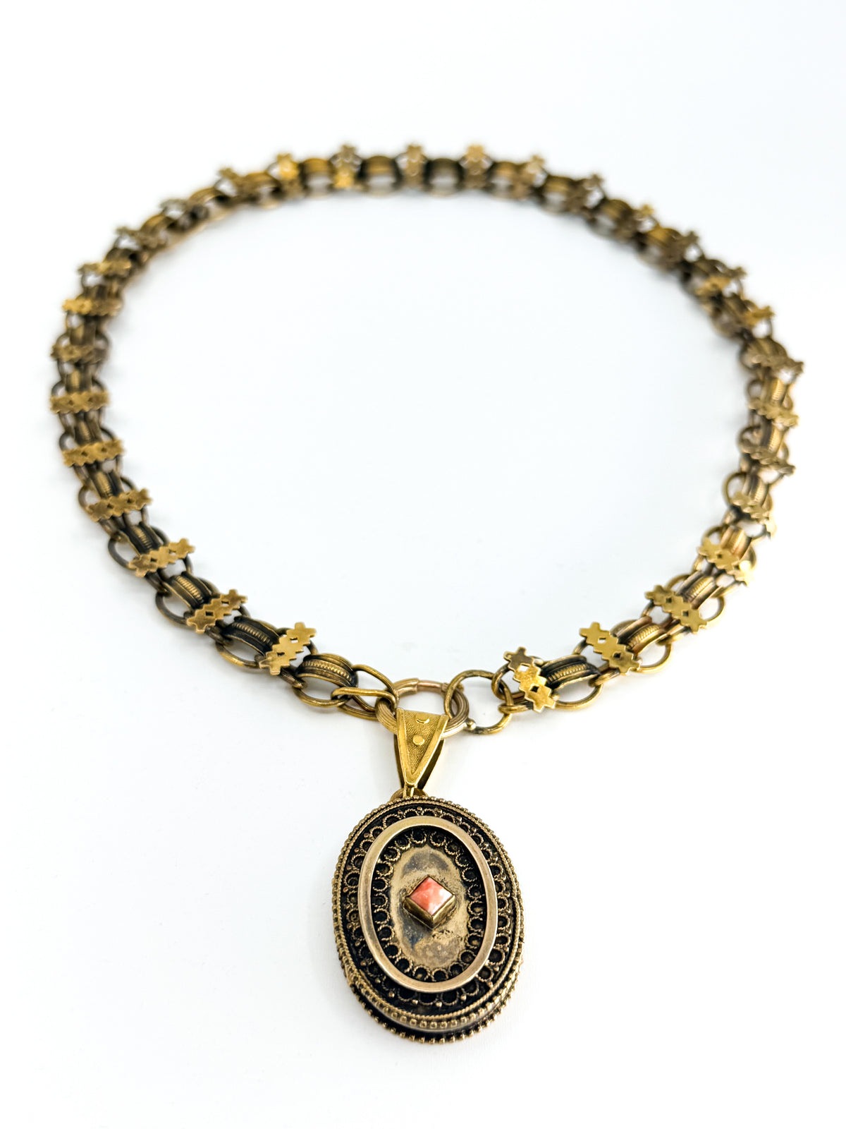 Victorian book chain necklace and locket with coral flat lay
