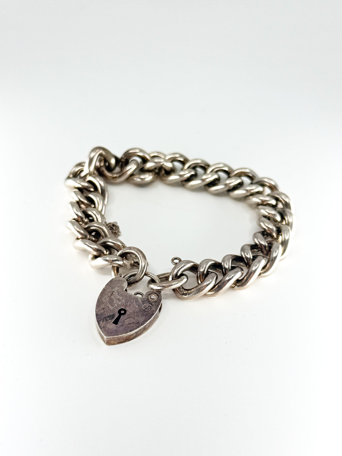 Heavy vintage sterling silver curb bracelet with padlock heart clasp