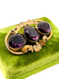 Victorian amethyst glass three-stone brooch