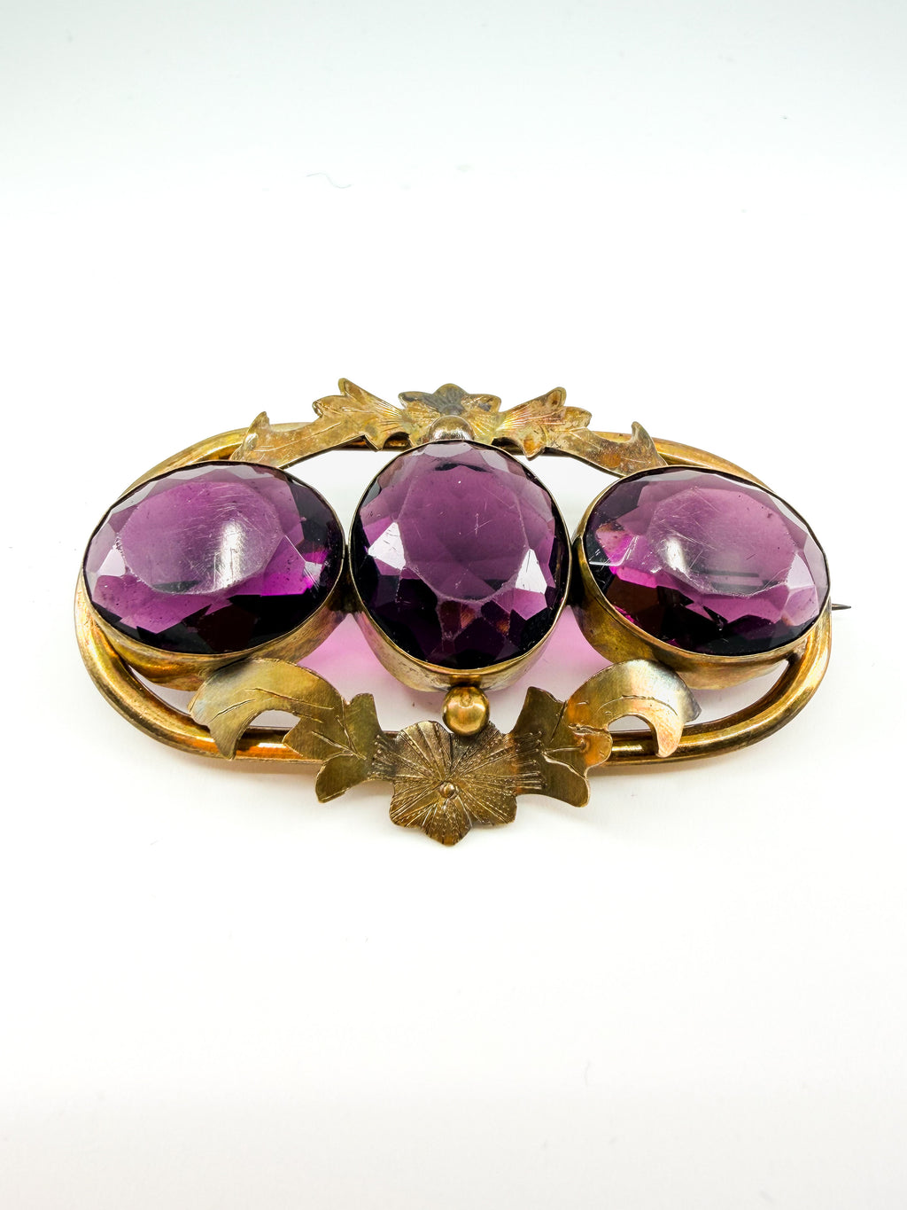 Victorian amethyst glass three-stone brooch