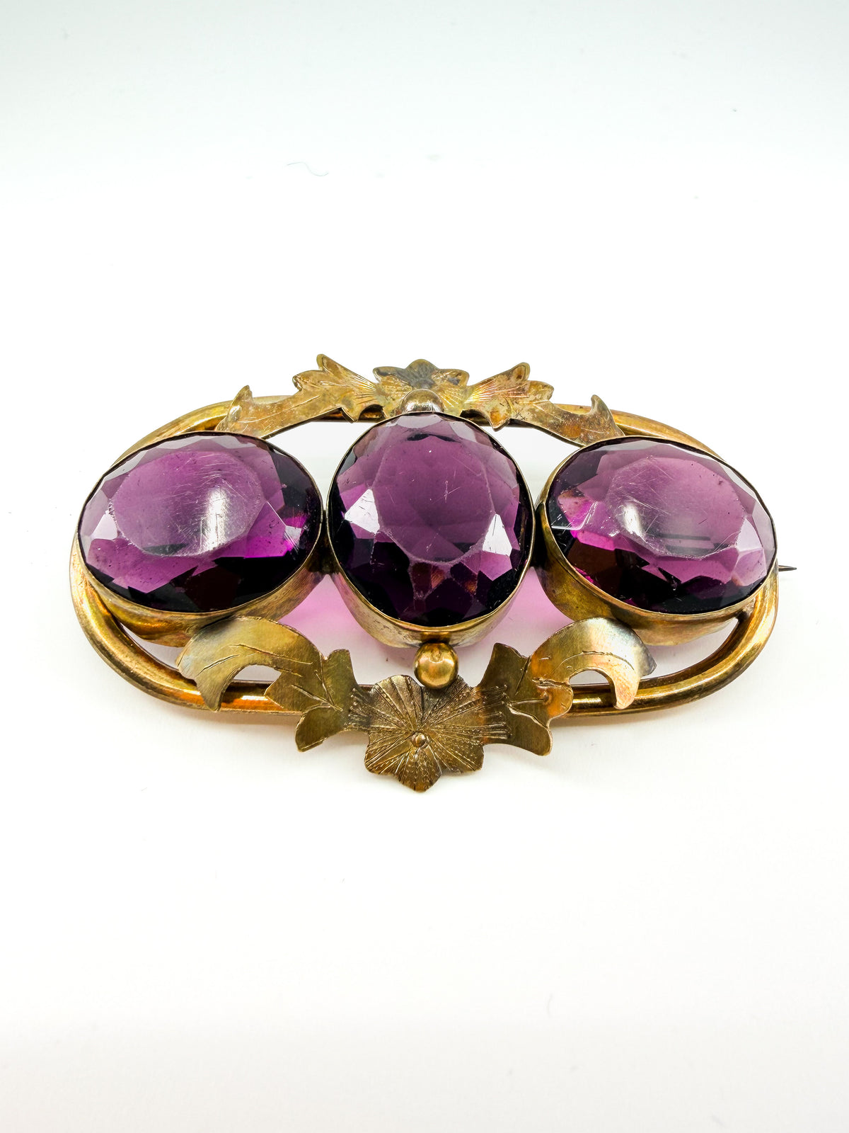 Victorian amethyst glass three-stone brooch