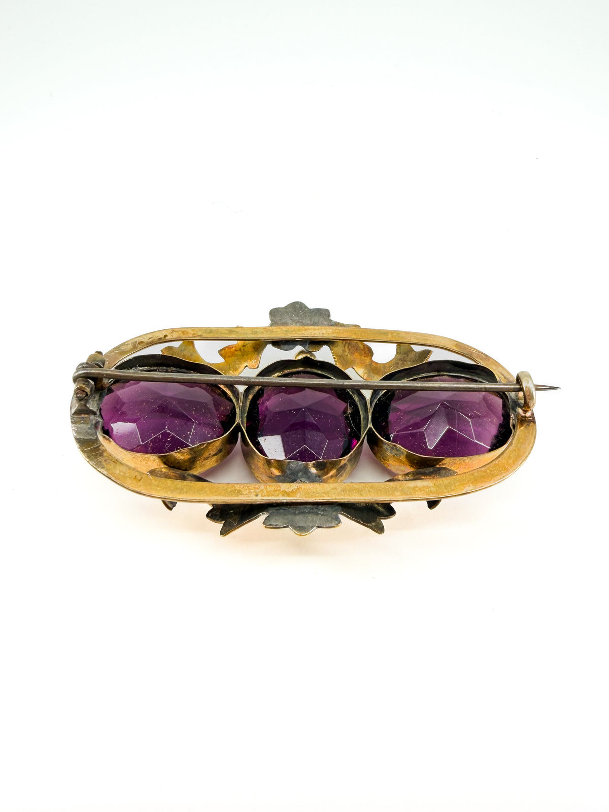 Victorian amethyst glass three-stone brooch
