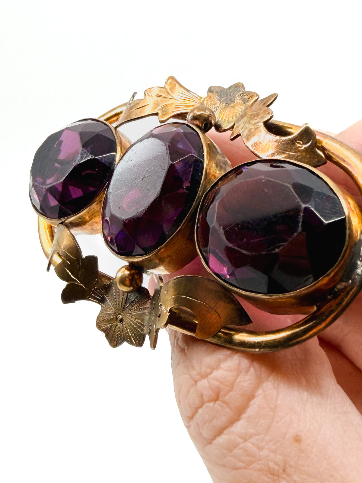 Victorian amethyst glass three-stone brooch